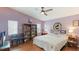 Comfortable bedroom featuring an oversized ceiling fan and a large bookcase at 2760 Siesta Dr, Venice, FL 34293