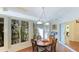 Cozy breakfast nook with windows providing scenic views of the lush landscape and bright sunlight at 2760 Siesta Dr, Venice, FL 34293
