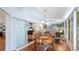Sunroom dining area connected to living area and featuring a wooden table with views of the outdoors at 2760 Siesta Dr, Venice, FL 34293