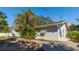 Exterior elevation of the home featuring a charming deck and lush, tropical landscaping at 2760 Siesta Dr, Venice, FL 34293