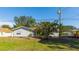 Charming single-story home with well-maintained lawn, mature trees, and partially covered front porch at 2760 Siesta Dr, Venice, FL 34293