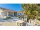 Inviting front yard with outdoor seating and lush tropical landscaping, perfect for relaxing at 2760 Siesta Dr, Venice, FL 34293
