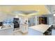 Updated kitchen features white cabinetry, stainless steel appliances, and eat in island with natural lighting at 2760 Siesta Dr, Venice, FL 34293