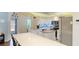 Bright kitchen featuring white cabinetry, a large island, stainless steel appliances and stylish backsplash at 2760 Siesta Dr, Venice, FL 34293