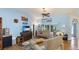 Bright living room with high ceilings, hardwood floors, comfortable seating, and large windows for natural light at 2760 Siesta Dr, Venice, FL 34293