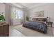 This bedroom is bright with a large window, stylish curtains, and elegant decor with plants throughout at 3166 Cabo St, North Port, FL 34291