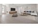 Spacious living room with tile floors, modern decor, and a large television at 3166 Cabo St, North Port, FL 34291