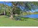 Enjoy the view of the lake from the shaded picnic area with lush green grass at 3656 Lake Bayshore Dr # 319 Bldg K, Bradenton, FL 34205