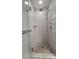 Glass shower with a mosaic tile floor, shower head, and sleek fixtures at 3706 54Th W Dr # 202, Bradenton, FL 34210