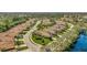 Exterior aerial view of single-Gathering homes featuring a nearby body of water and lush green landscaping at 3872 Mira Lago Dr, Sarasota, FL 34238