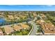 Exterior aerial view of single Gathering homes in a well-maintained community with mature trees and lush landscaping at 3872 Mira Lago Dr, Sarasota, FL 34238