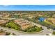 Picture of homes in a well-maintained lakeside community with beautiful lawns, mature trees, and easy street access at 3872 Mira Lago Dr, Sarasota, FL 34238