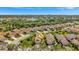 Exterior aerial shot showcasing well-maintained homes with terracotta roofs, lush landscaping, and mature tree coverage at 3872 Mira Lago Dr, Sarasota, FL 34238