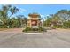 Community gate with beautiful stone work and landscaping at 3872 Mira Lago Dr, Sarasota, FL 34238