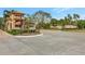 Community entrance sign, Mira Lago Main Gate, landscaped with mature trees, bushes, and brick driveways at 3872 Mira Lago Dr, Sarasota, FL 34238