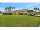 Beautiful single-story home with a well-manicured lawn and lush landscaping at 3872 Mira Lago Dr, Sarasota, FL 34238