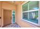 Front porch with brick floor, large window and craftsman style front door at 3872 Mira Lago Dr, Sarasota, FL 34238