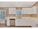 Well-lit kitchen with white cabinetry, modern stainless steel appliances, and tile backsplash at 3872 Mira Lago Dr, Sarasota, FL 34238