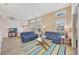 Bright living room featuring blue sofas, a ceiling fan, and many windows letting in natural light at 3872 Mira Lago Dr, Sarasota, FL 34238