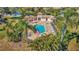 Community pool with lounge chairs, cabana, palm trees and landscaping at 3872 Mira Lago Dr, Sarasota, FL 34238