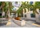 Elegant courtyard with lush palm trees leading to the entrance of the building at 400 4Th S Ave # 1203, St Petersburg, FL 33701