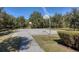 Outdoor community basketball court with hoops, set amidst lush greenery and trees at 4307 70Th E Ave, Ellenton, FL 34222