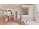 Bathroom featuring a large vanity, soaking tub, and separate glass-enclosed shower at 4307 70Th E Ave, Ellenton, FL 34222