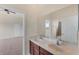 Well-lit bathroom featuring double sinks, a large mirror, and access to the bedroom and shower area at 4307 70Th E Ave, Ellenton, FL 34222