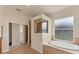 Bright bathroom with a soaking tub, walk-in shower and ceramic tile flooring at 4307 70Th E Ave, Ellenton, FL 34222