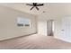 Comfortable bedroom with neutral carpet, ceiling fan, and a window offering a pleasant view at 4307 70Th E Ave, Ellenton, FL 34222