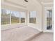 Light-filled bedroom with neutral carpet, large windows overlooking the lush outdoors and a patio door at 4307 70Th E Ave, Ellenton, FL 34222