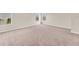 Spacious bedroom with neutral carpet, base trim, and two large windows for plenty of natural light at 4307 70Th E Ave, Ellenton, FL 34222