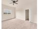 Large bedroom features plush carpet, a ceiling fan, and a sunny window with an outdoor view at 4307 70Th E Ave, Ellenton, FL 34222