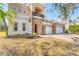 Charming home with a red door, stone accents, and a three-car garage with brick paved driveway at 4307 70Th E Ave, Ellenton, FL 34222