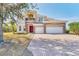 Elegant two-story home with a three-car garage, stone accents, and a manicured front yard at 4307 70Th E Ave, Ellenton, FL 34222