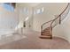 Grand two-story foyer with curved staircase, neutral carpet, and an abundance of natural light at 4307 70Th E Ave, Ellenton, FL 34222