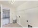 Convenient laundry room with a utility sink, shelving, and access to the garage space at 4307 70Th E Ave, Ellenton, FL 34222