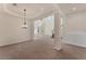 Sunlit living room highlighting high ceilings, pillars, staircase, and neutral finishes at 4307 70Th E Ave, Ellenton, FL 34222