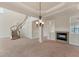 Elegant living area showcasing a winding staircase, fireplace, and contemporary lighting at 4307 70Th E Ave, Ellenton, FL 34222