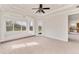 Spacious main bedroom with tray ceilings, backyard views, carpet flooring, and a private exterior access door at 4307 70Th E Ave, Ellenton, FL 34222