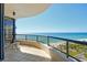 Enjoy incredible ocean views from this condo's curved balcony with seating area at 435 L Ambiance Dr # L807, Longboat Key, FL 34228