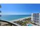 Breathtaking ocean view from a condo balcony overlooking a pool, beach and palm trees at 435 L Ambiance Dr # L807, Longboat Key, FL 34228