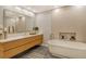 Modern bathroom boasts dual vanities, a soaking tub, and a sleek design at 435 L Ambiance Dr # L807, Longboat Key, FL 34228