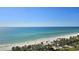 Stunning ocean view featuring a pristine white sand beach, palm trees, and turquoise waters at 435 L Ambiance Dr # L807, Longboat Key, FL 34228