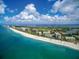 A clear, beautiful aerial view of the beachfront with a line of beachfront condos and resorts at 435 L Ambiance Dr # L807, Longboat Key, FL 34228
