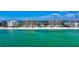 Expansive beachfront view of high-rise condos alongside white sandy beach and turquoise ocean water at 435 L Ambiance Dr # L807, Longboat Key, FL 34228