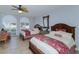 Comfortable bedroom with two beds, ceiling fan, tile floor, window, and natural light at 435 L Ambiance Dr # L807, Longboat Key, FL 34228