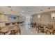 Beautiful clubhouse with tables, chairs, kitchen, counter, TV, and marble floors at 435 L Ambiance Dr # L807, Longboat Key, FL 34228