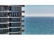 Contemporary condo exterior featuring balconies and floor-to-ceiling windows, with stunning ocean view at 435 L Ambiance Dr # L807, Longboat Key, FL 34228