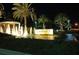 Elegant community entrance sign, showcasing water features, and beautiful landscaping at night at 435 L Ambiance Dr # L807, Longboat Key, FL 34228